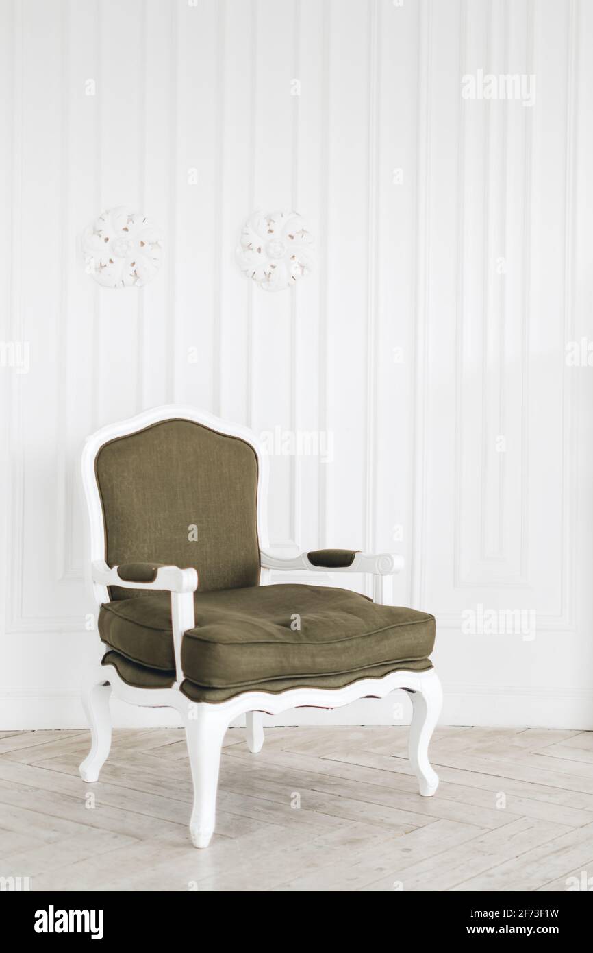 Comfortable vintage armchair in bright living room with minimalist ...