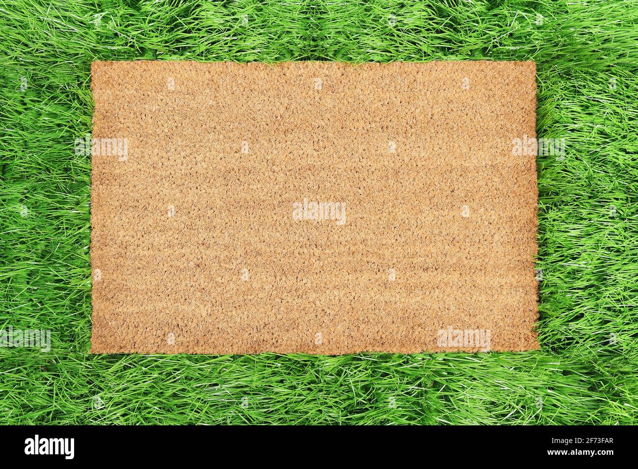 Coir doormat mockup Green grass spring background Stock Photo