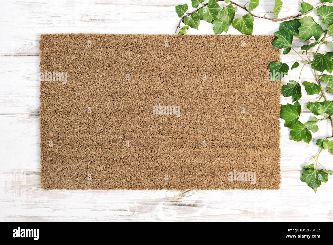 Coir doormat mock up. Floral template mockup on wooden background Stock Photo