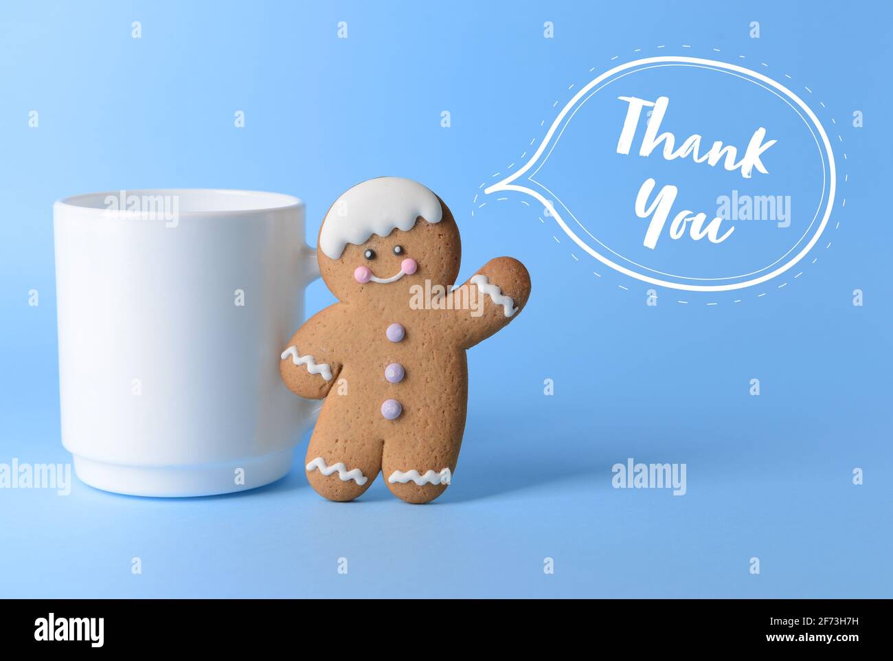 Cup with cookie on color background. Friendship Day celebration Stock Photo