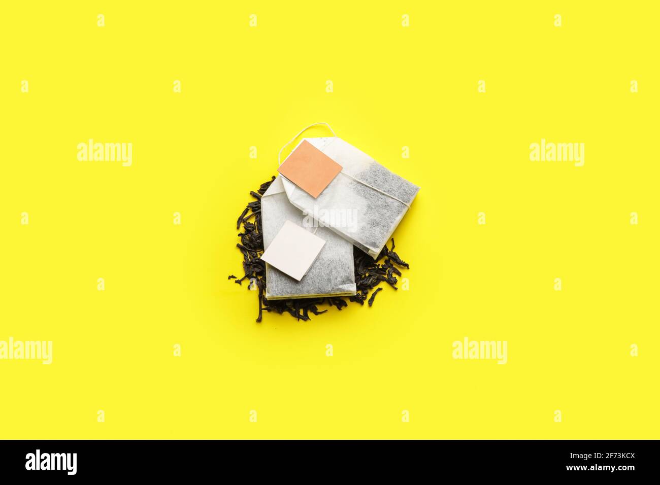 Tea bags and dry leaves on color background Stock Photo Alamy