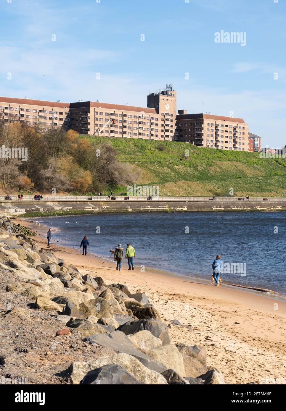 People walking along the Riverside path and on the Quayside sands in North Shields, northern England UK Stock Photo