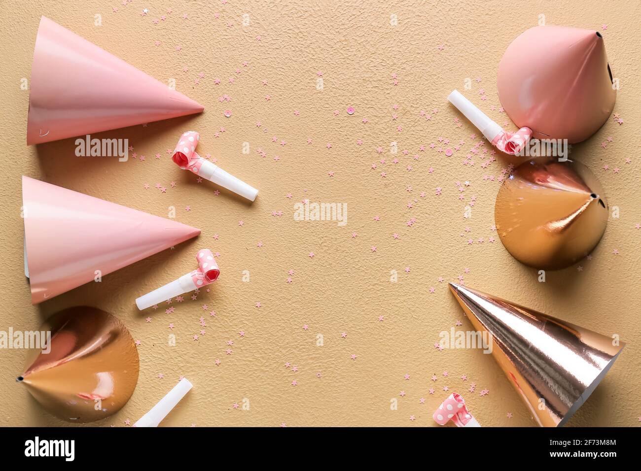 Party hats and whistles on color background Stock Photo - Alamy