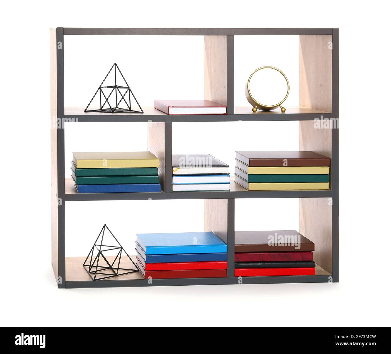 Modern shelf unit with books and decor on white background Stock Photo