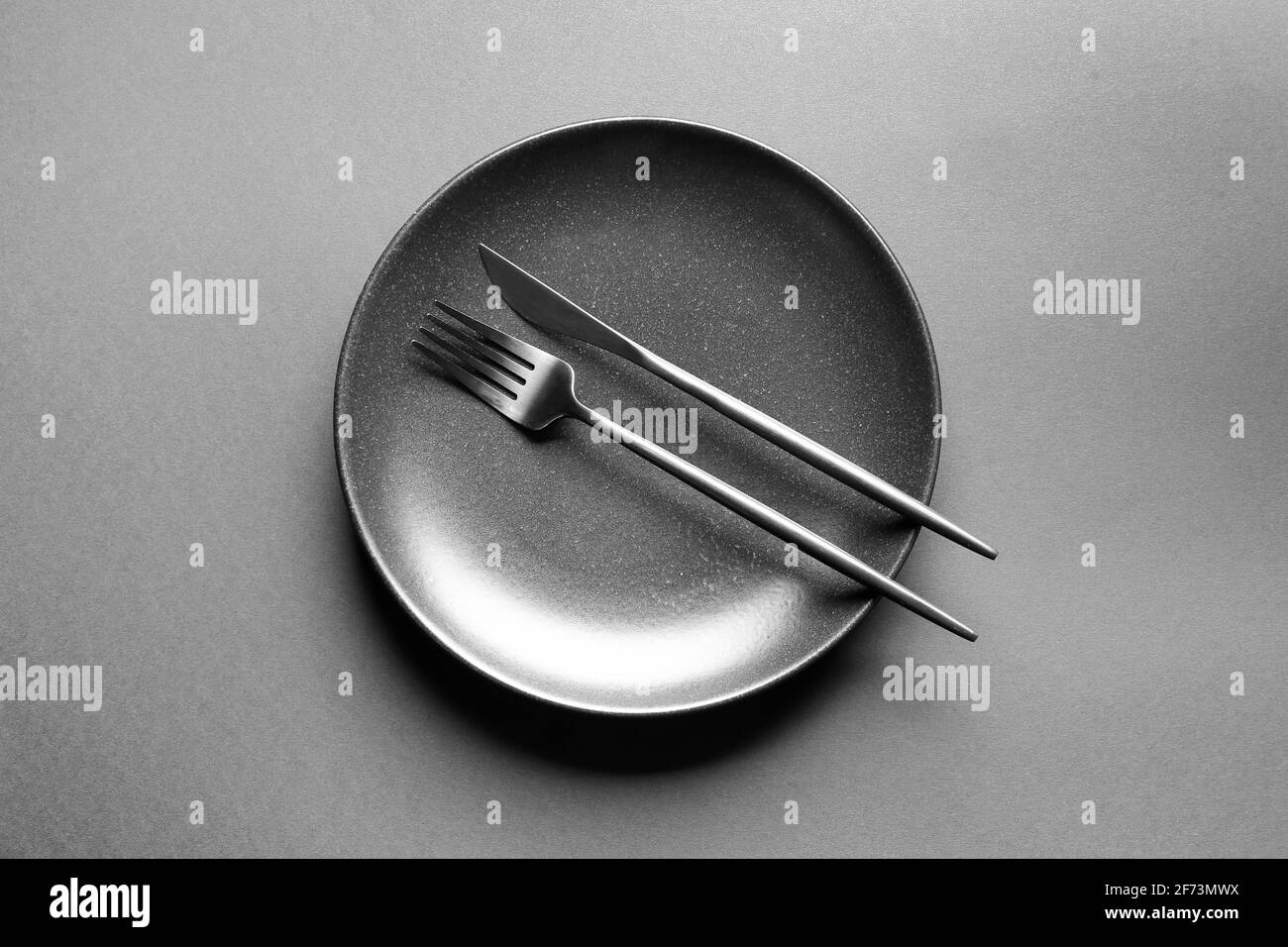 Plate and cutlery on dark background Stock Photo