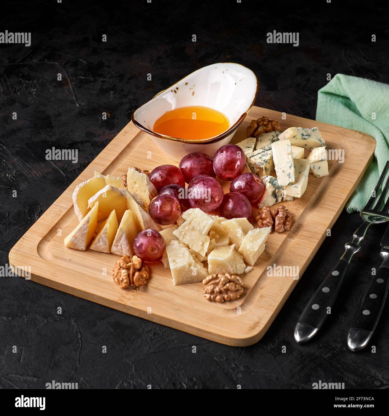 Assortment of cheese with fruits and grapes Stock Photo Alamy