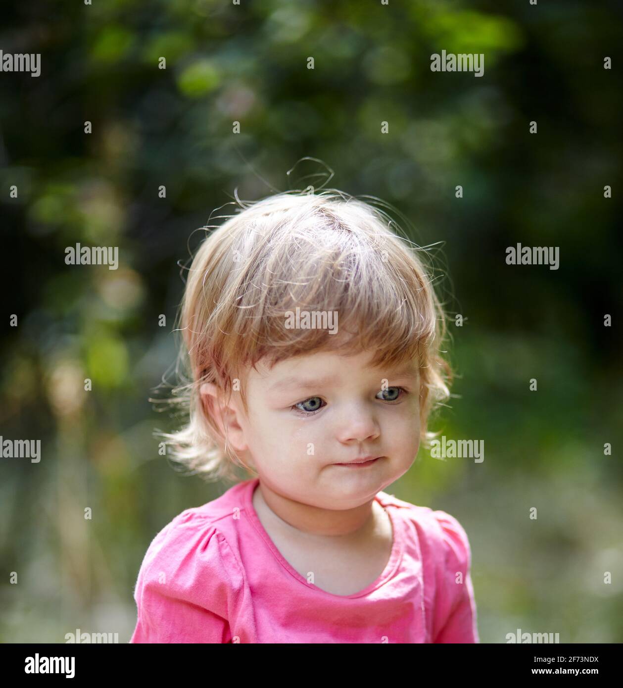 Sad child. Lonely little baby girl outdoors Stock Photo