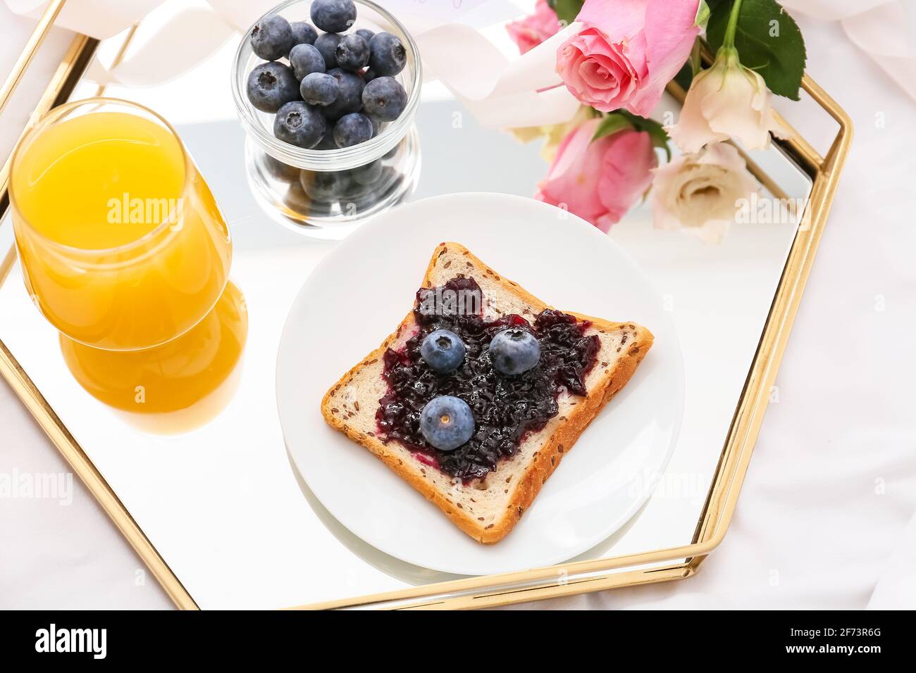 Tray with tasty breakfast on bed Stock Photo Alamy