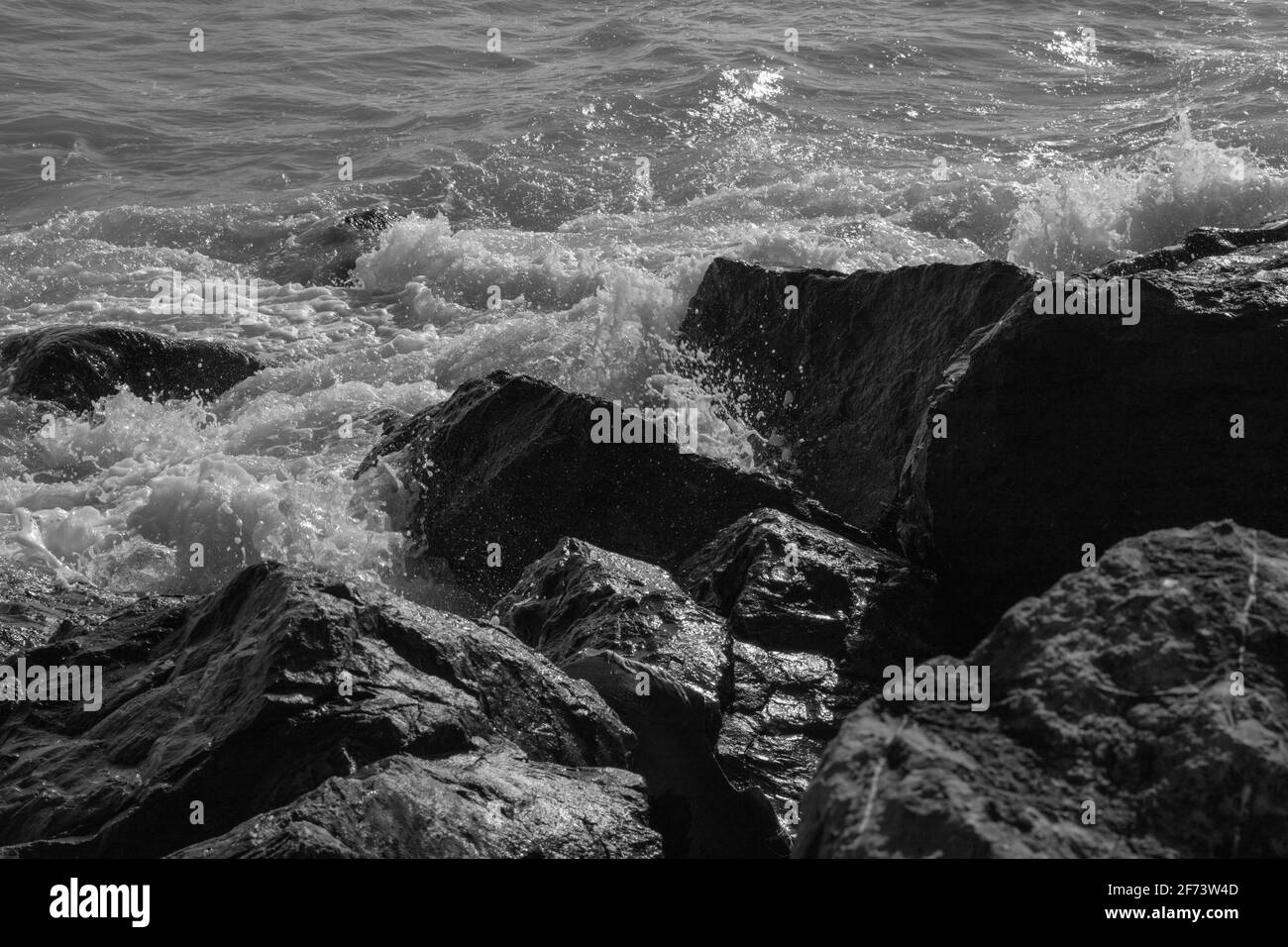 Black and white image of rocks and sea Stock Photo - Alamy