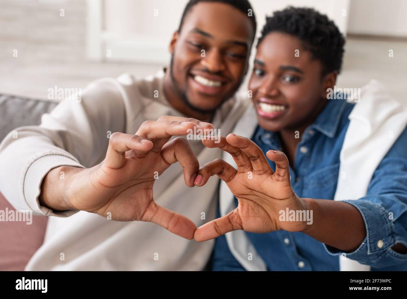 Portrait of african american couple making heart shape with hands Stock ...