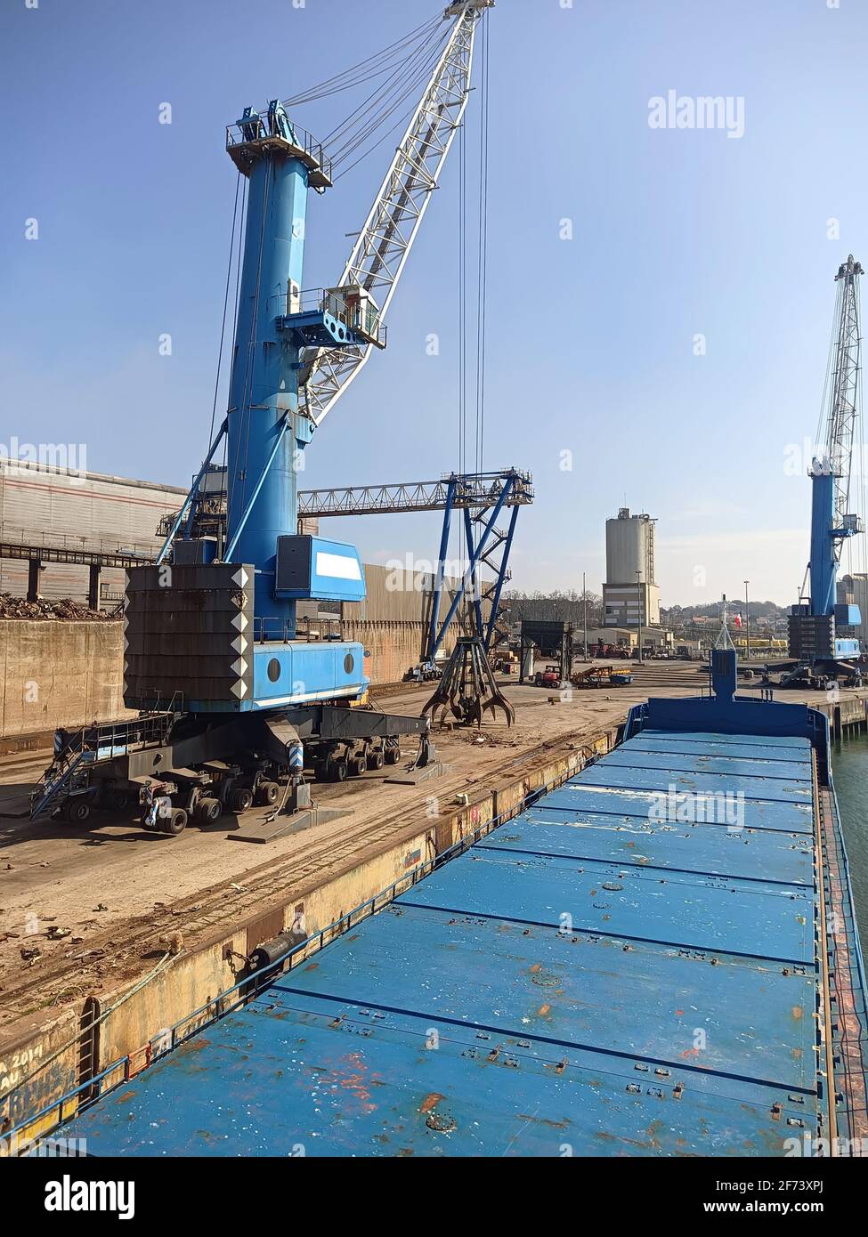 Crane manipulator with gripper in the port for loading scrap metal