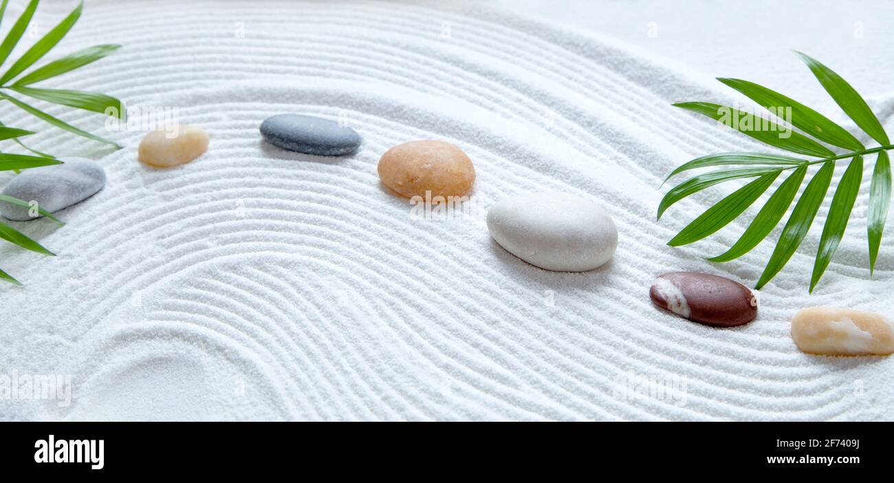 Zen garden with colorful pebbles and glitter light Stock Photo