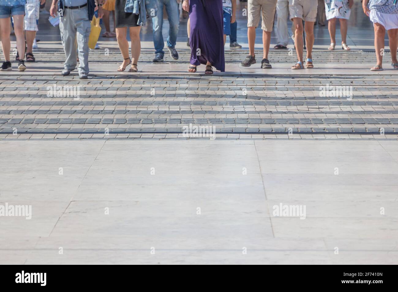 Large pedestrian crossing city crowd walk in motion on road. Many legs,  feet and shoes from different people walking on town street crosswalk in  hurry Stock Photo - Alamy