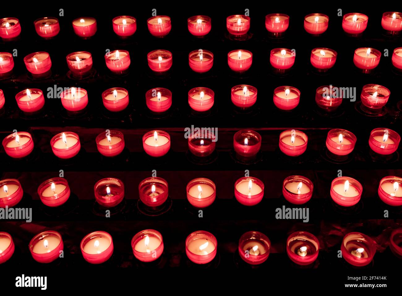 Group of red candles in church for faith resurrection prayer