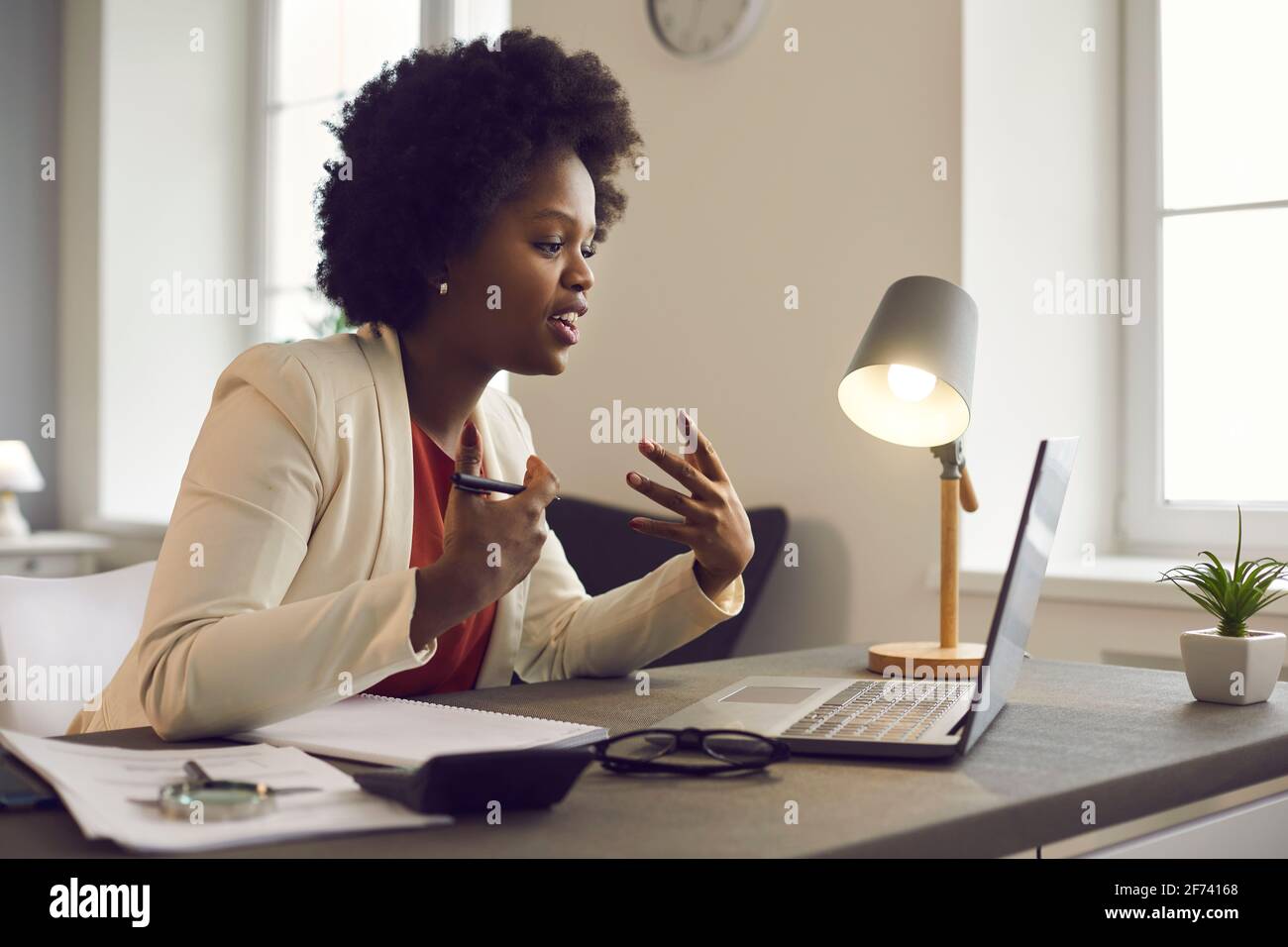 Young african american woman having conference video call via laptop in office Stock Photo