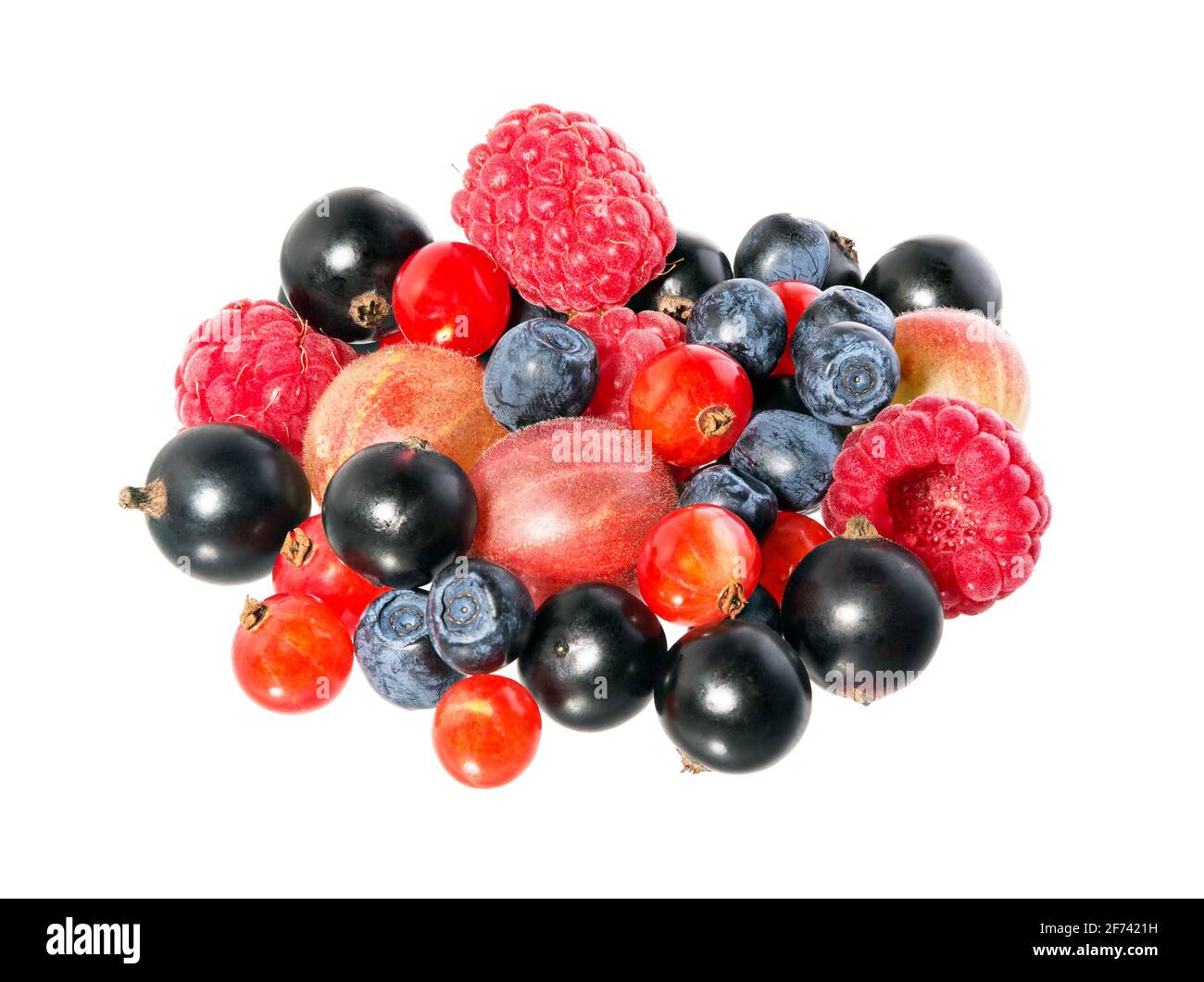 Mixed berries isolated on a white background. Fruit mix. A pile of berry fruits, blueberries, raspberries, currant black and red. Stock Photo