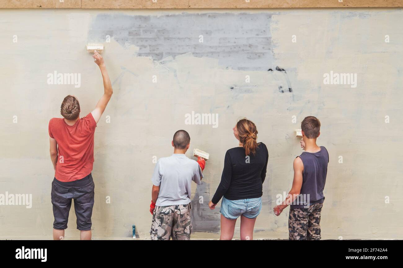 friends paint the wall and write text Stock Photo Alamy