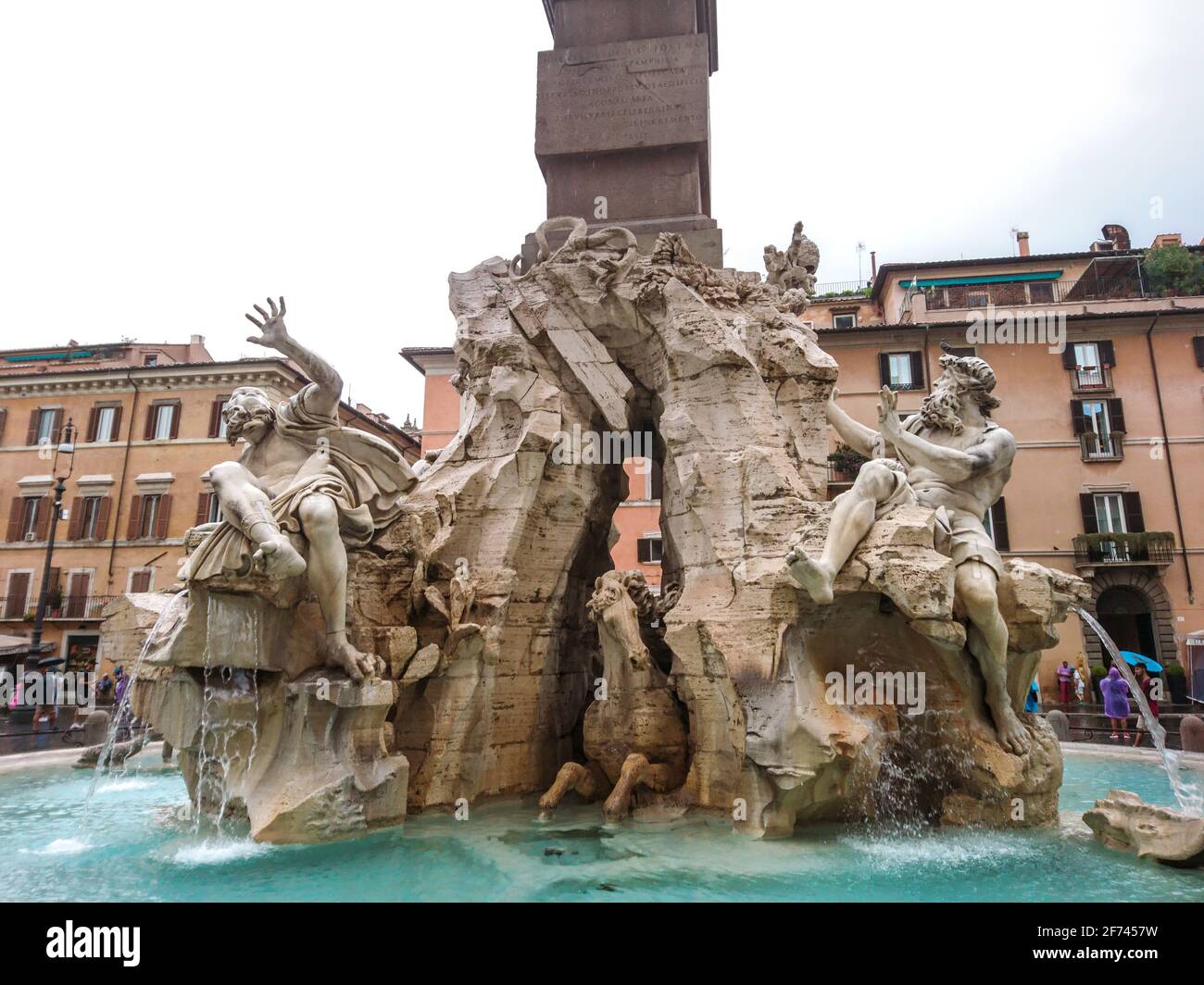 Rome, Italy - August 18, 2019: Bernini's Fountain of the Four Rivers sculptures close-up with Obelisco Agonale, ancient obelisk in the center, on clou Stock Photo
