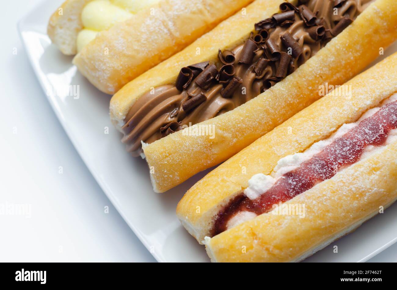 Mixed finger donuts filling chocolate, custard, jam and whipped cream