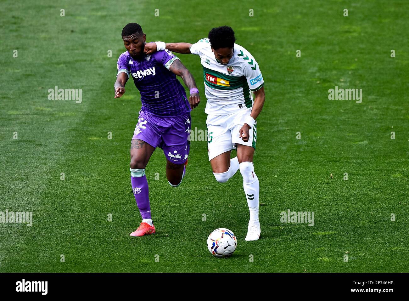 ELCHE, SPAIN - APRIL 4: Emerson of Real Betis and Johan Mojica of Elche CF battle for possession during the La Liga Santander match between Elche CF a Stock Photo