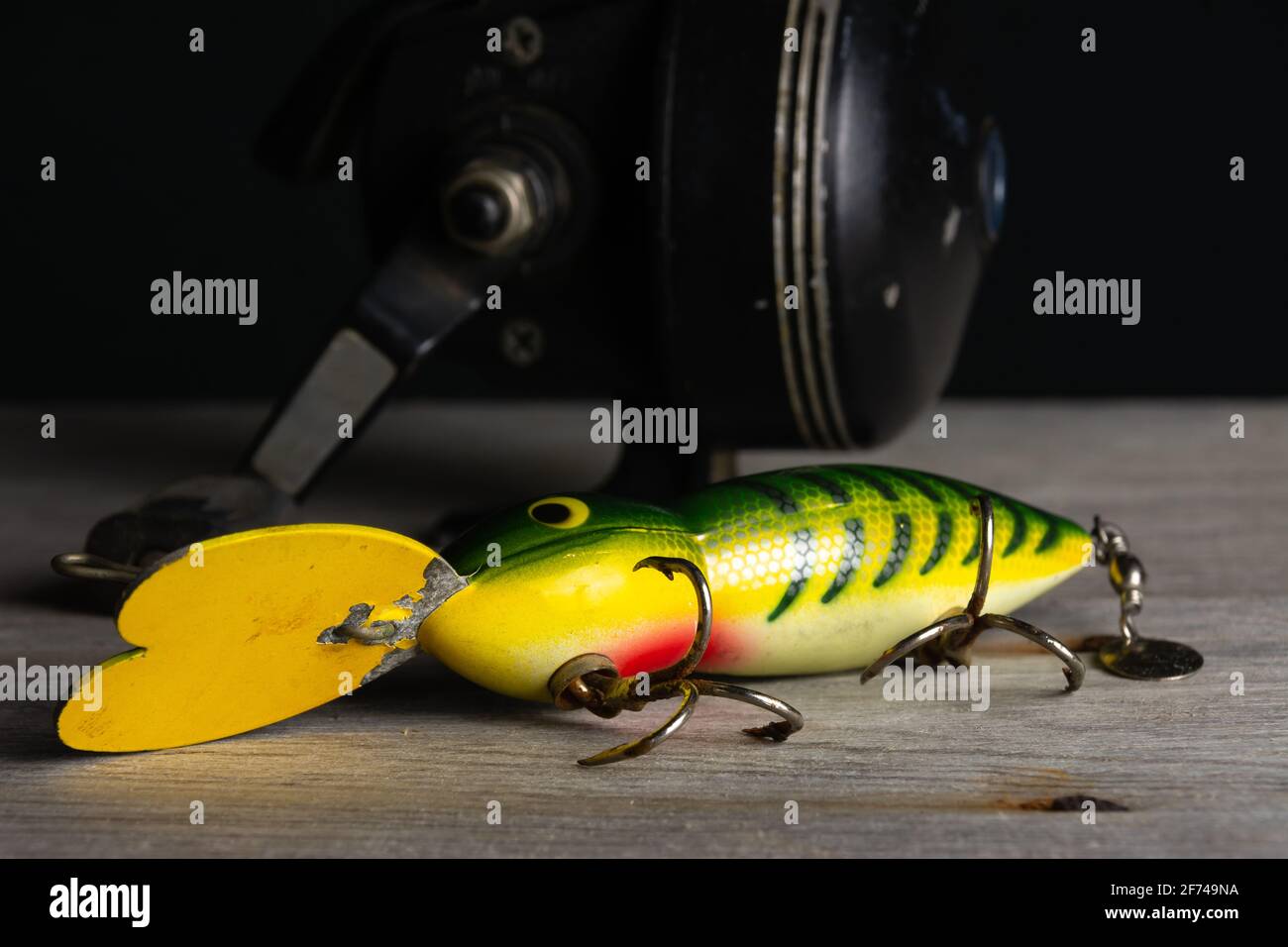 Vintage fishing tackle on old wood and black background Stock Photo - Alamy