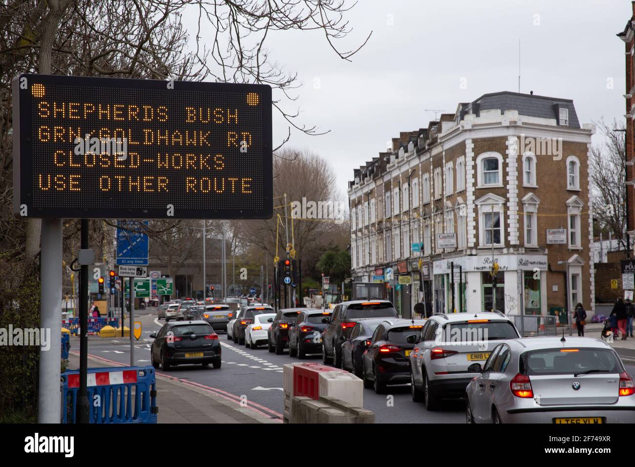 Traffic jam along with sign warning of road closures. Chiswick High Road, London, UK Stock Photo