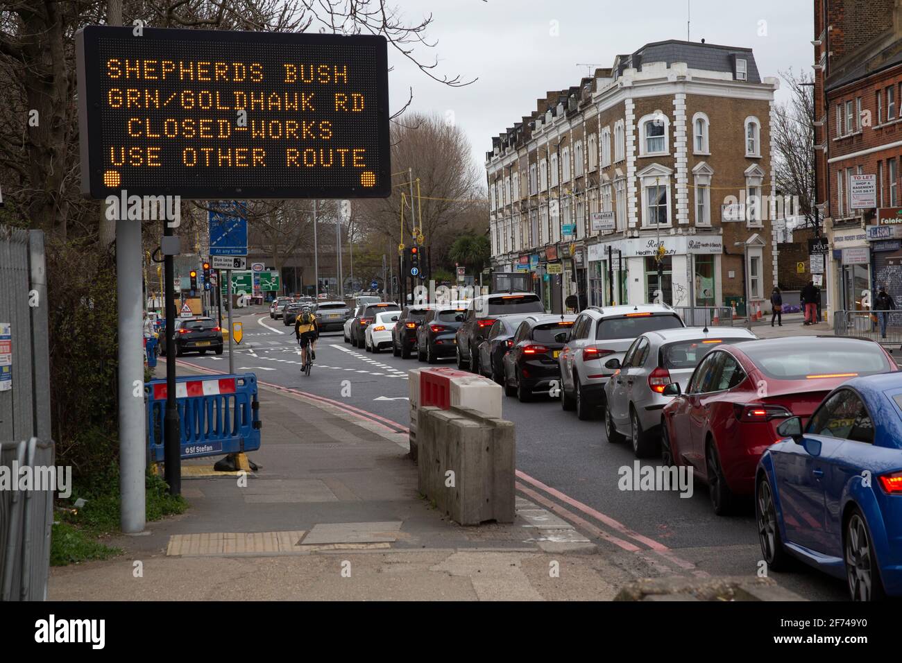 Traffic jam along with sign warning of road closures. Chiswick High Road, London, UK Stock Photo