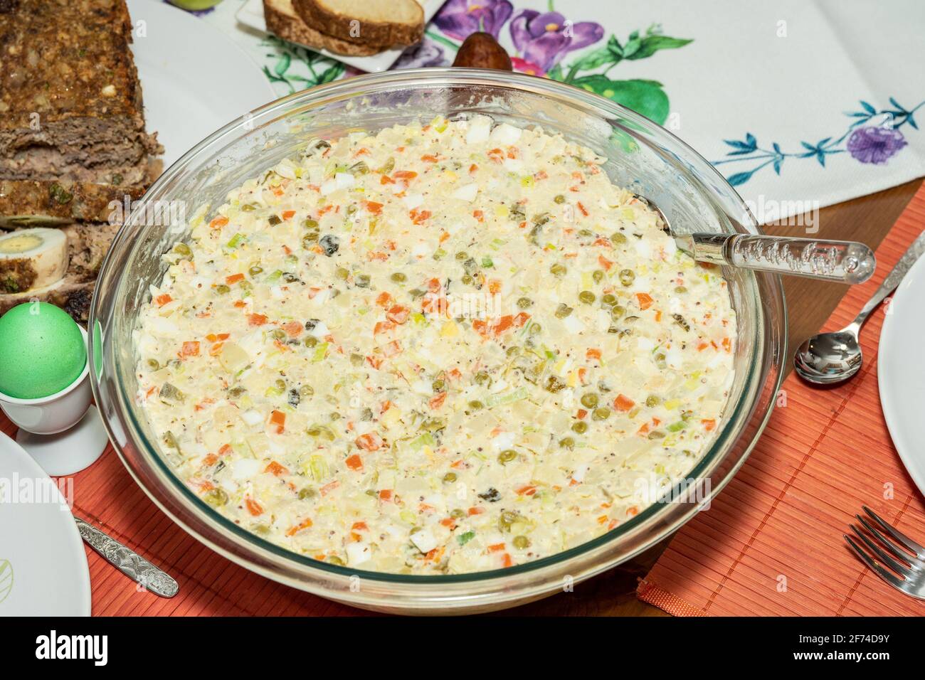 Salade Olivier is a salad composed of diced potato, vegetables, and sometimes meats bound in mayonnaise. Stock Photo