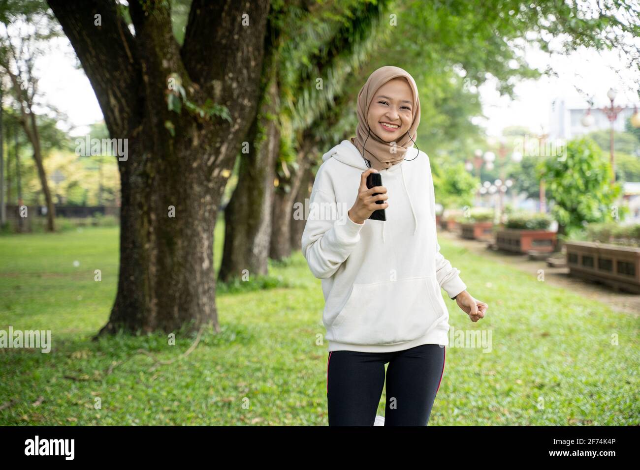 muslim woman running outdoor during ramadan fasting Stock Photo