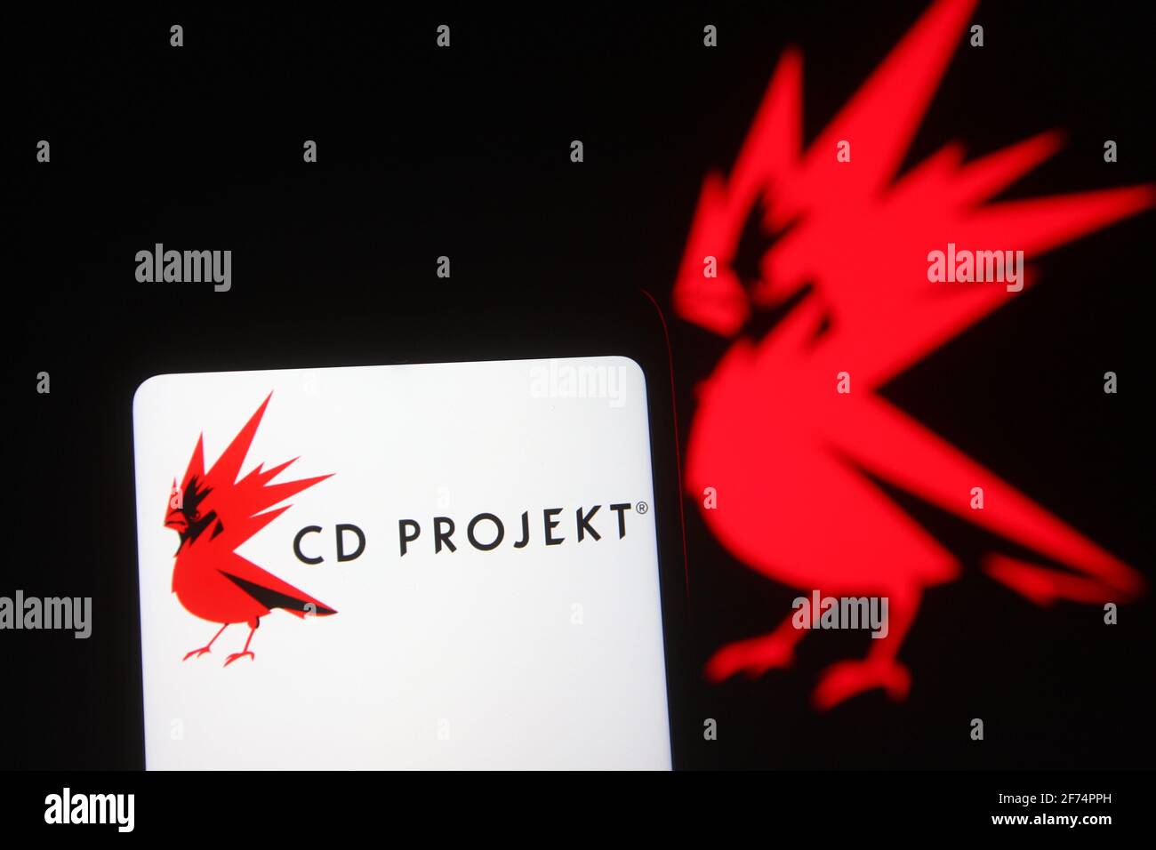In this photo illustration the CD Projekt logo of a video game developer is  seen on a smartphone and a pc screen Stock Photo - Alamy