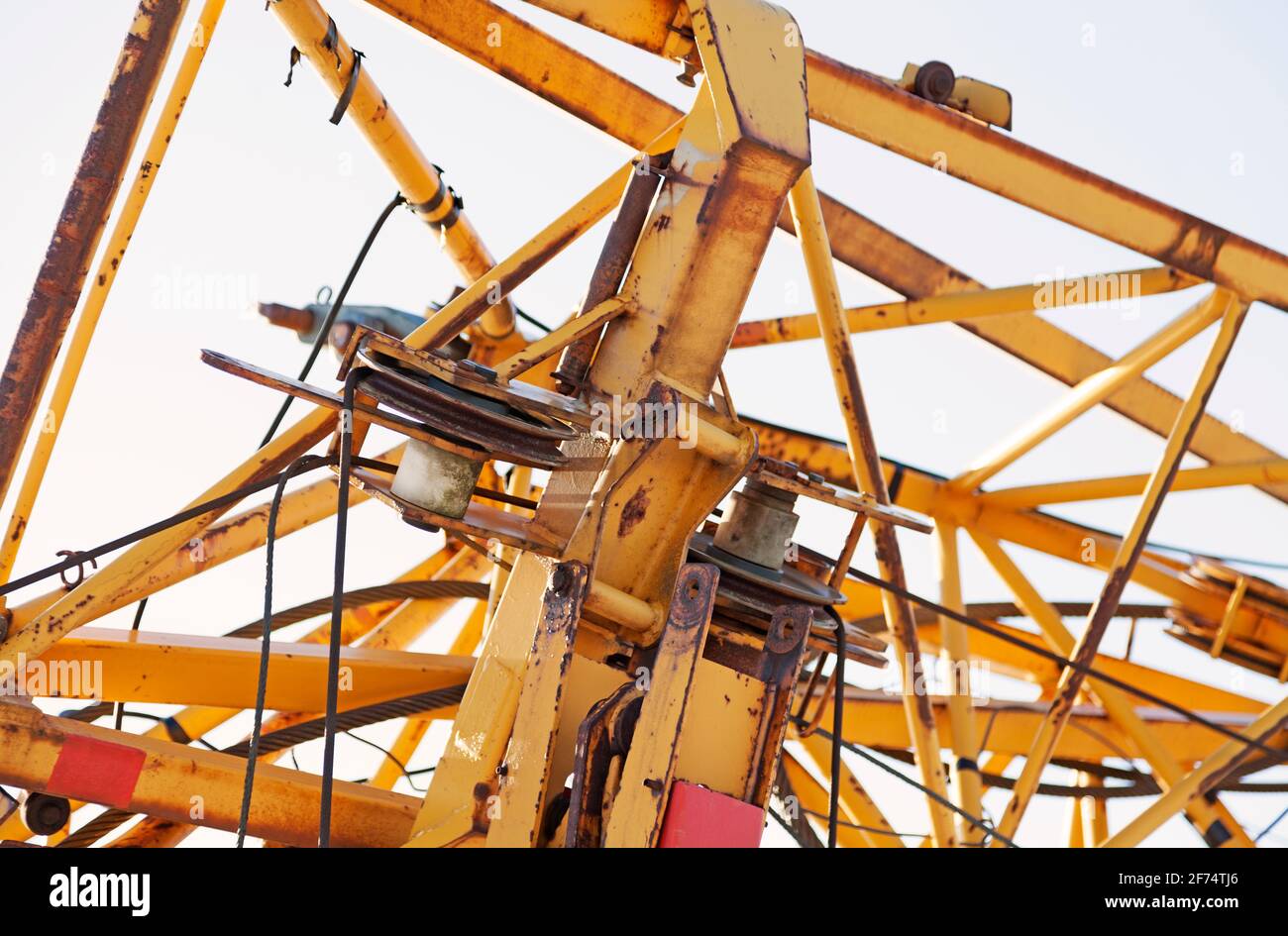 part of a yellow folded construction crane Stock Photo