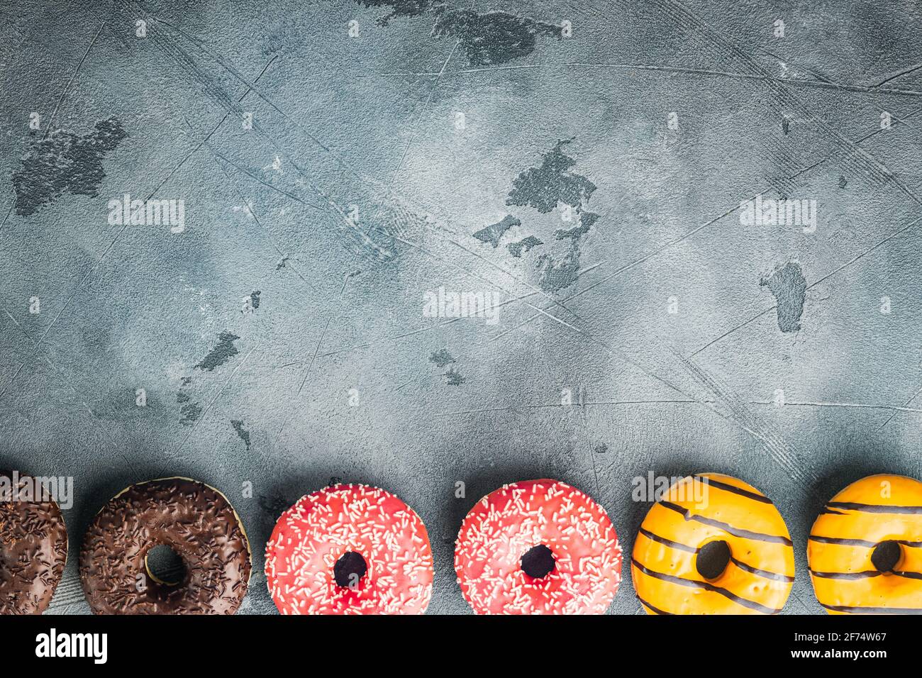 Glazed donuts set, on gray background, top view flat lay with copy space for text Stock Photo