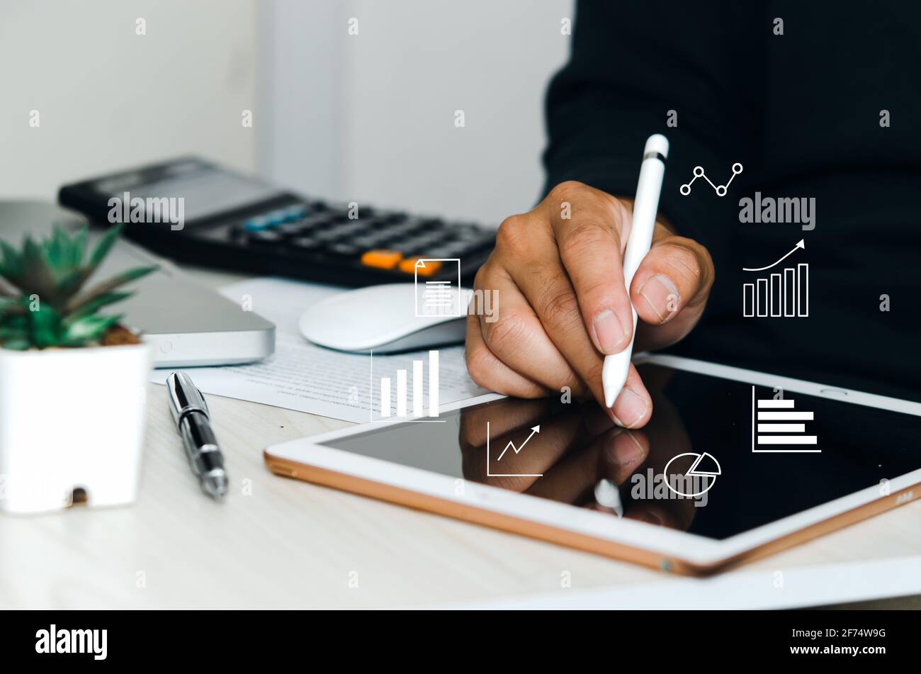 Man using  digital tablet or work on table, icon graph  business concept. Stock Photo
