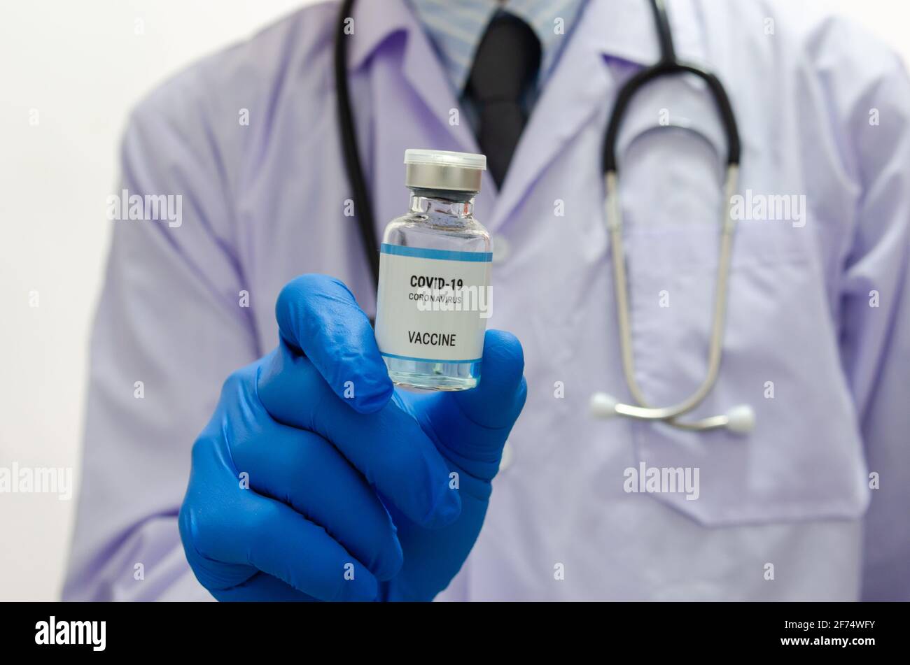 Doctor or laborant holding COVID-19 vaccine tube Or coronavirus vaccine. Coronavirus Vaccine concept. Stock Photo