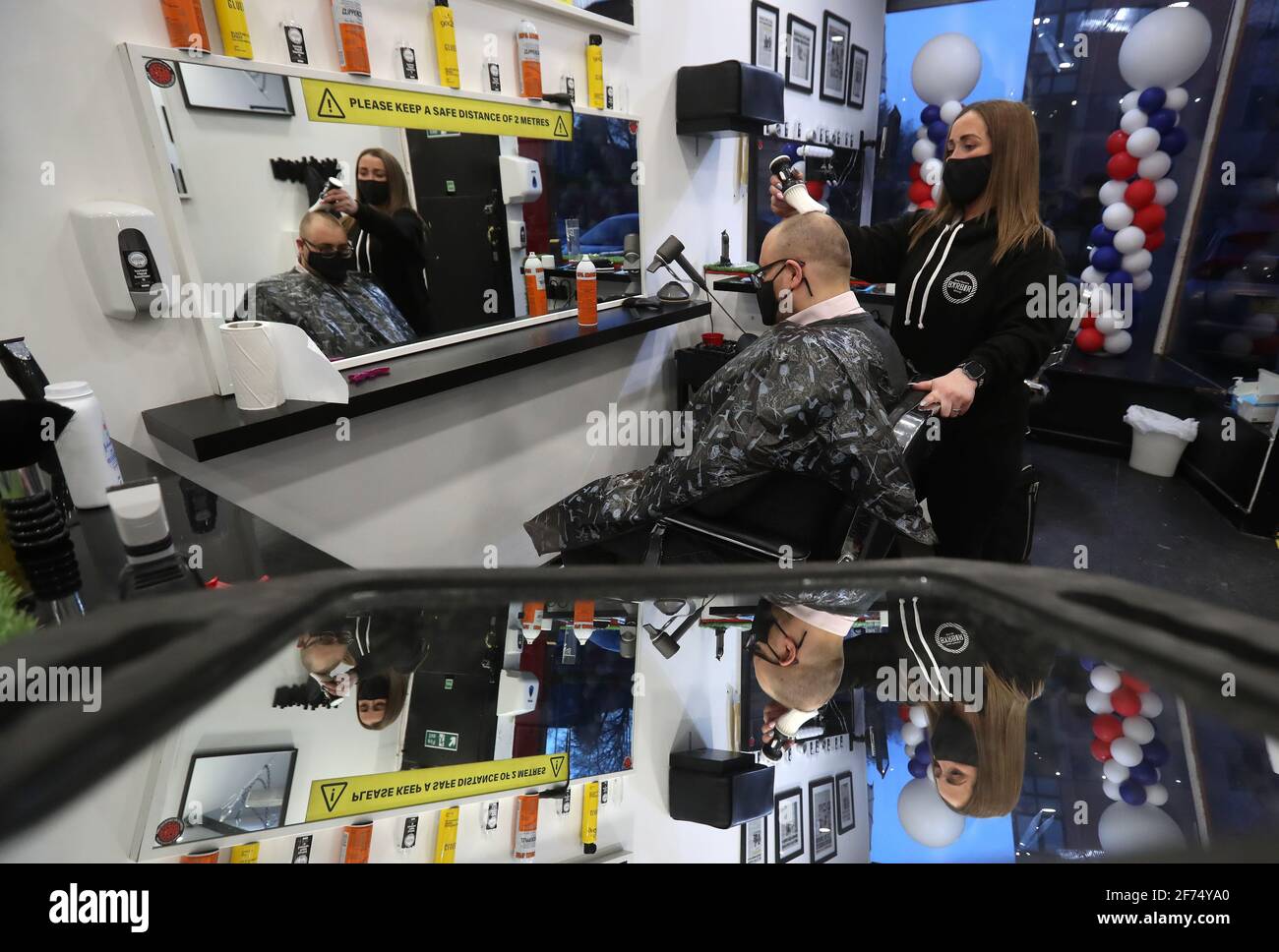 Barber Maggie McGillivray trims Sam Rosenblom's hair at Tony Mann's