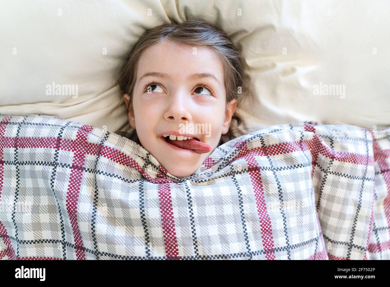 Child tucked in blanket hires stock photography and images Alamy