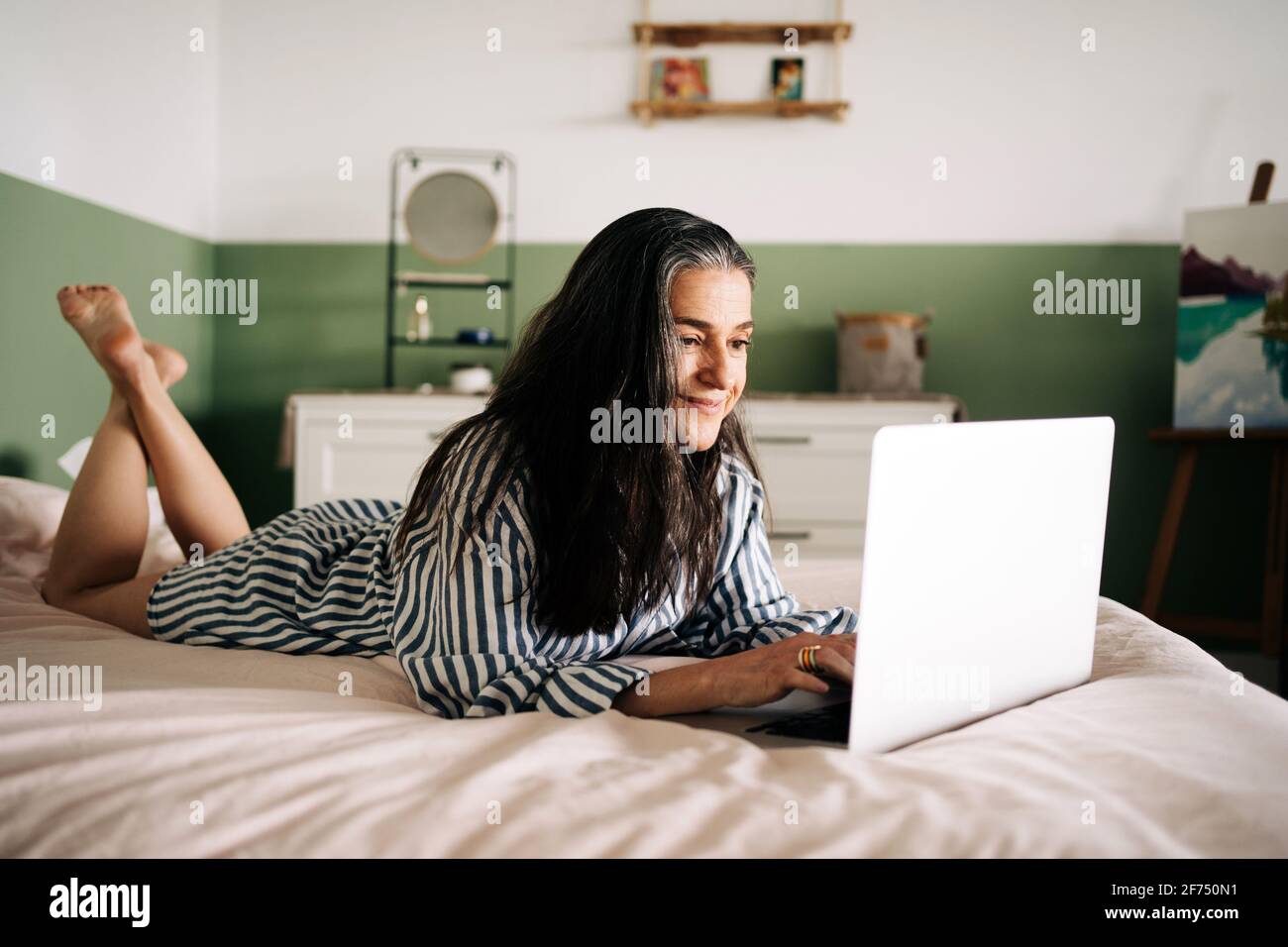 Positive mature woman typing laptop hi-res stock photography and images ...