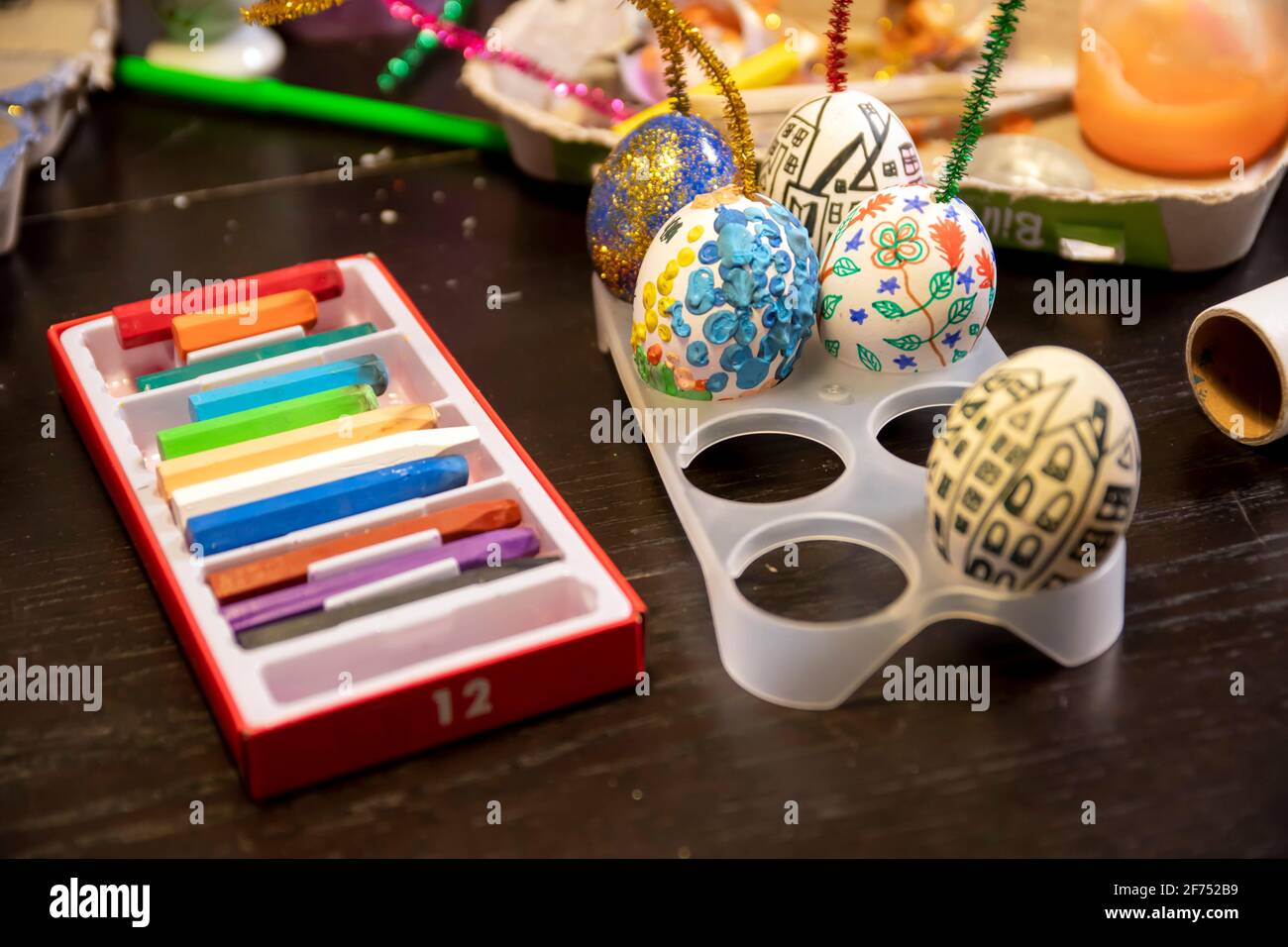 Easter egg painting and decorating activity concept: Colorful handmade Easter eggs. Preparation for the holidays. Stationary objects on the table. Stock Photo