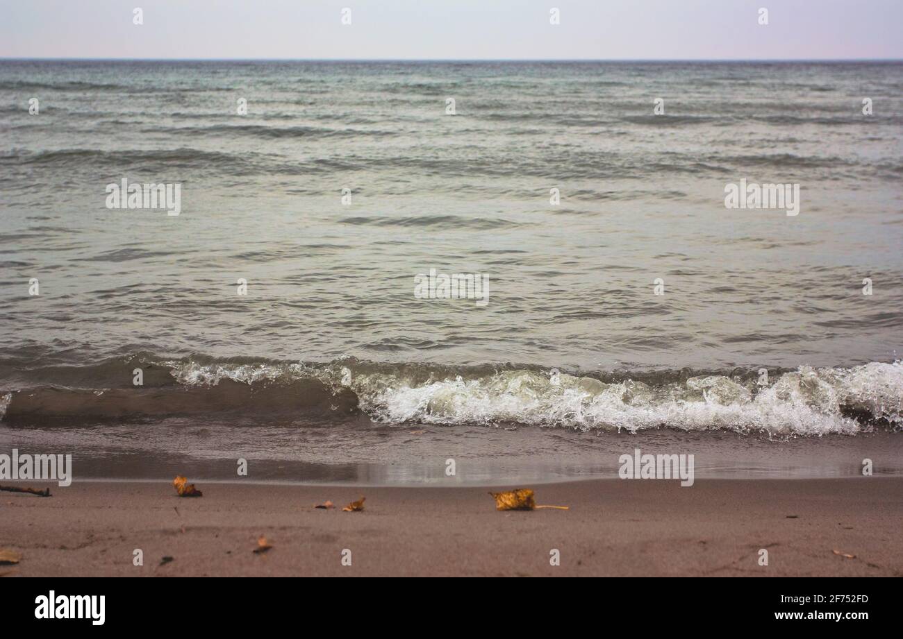 Waves rolling into shore on a beach in Toronto, Ontario, Canada. Stock Photo