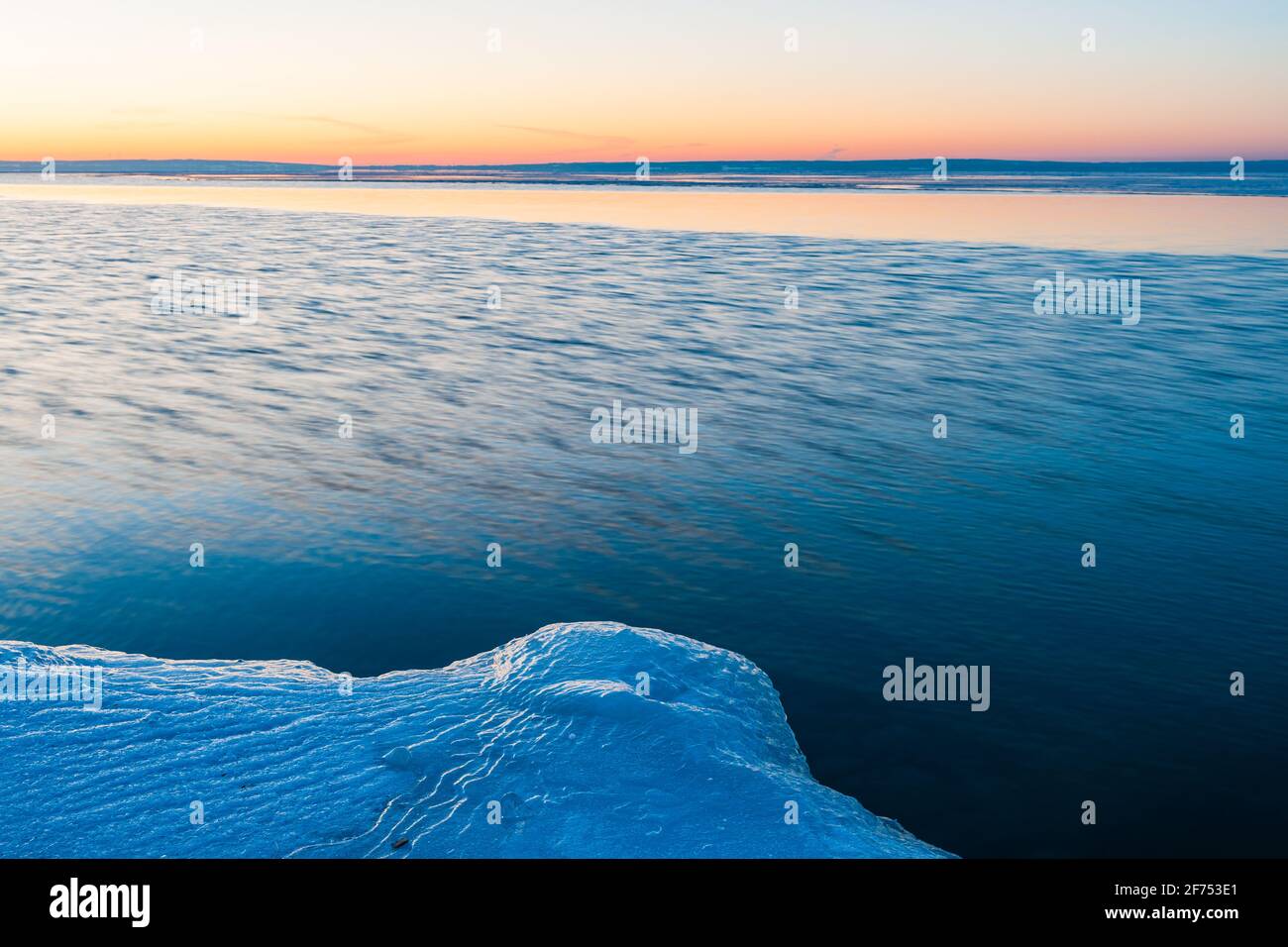 Icy shoreline in front of lake Stock Photo