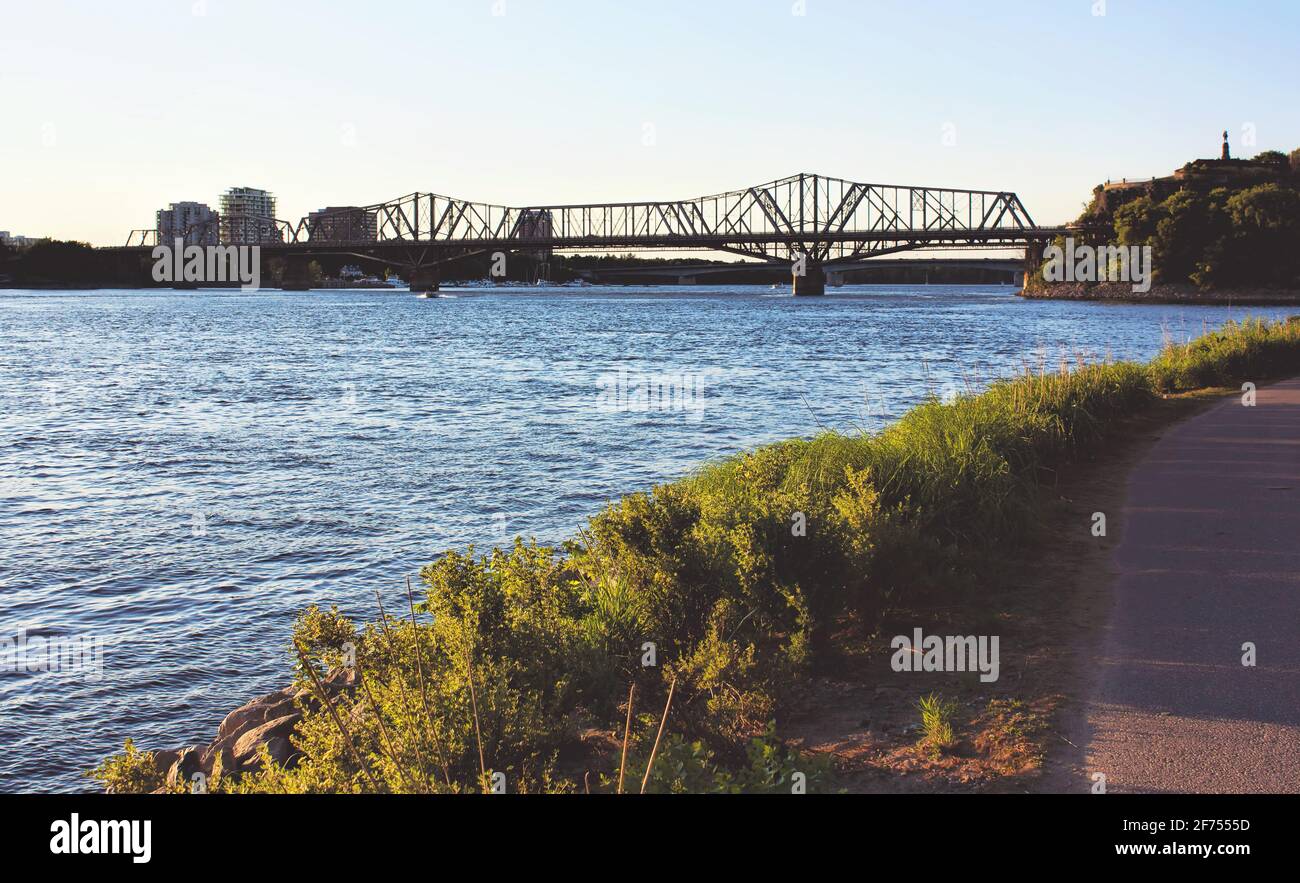 A bridge surrounded by water under a sunny sky in Ottawa, Canada. Stock Photo