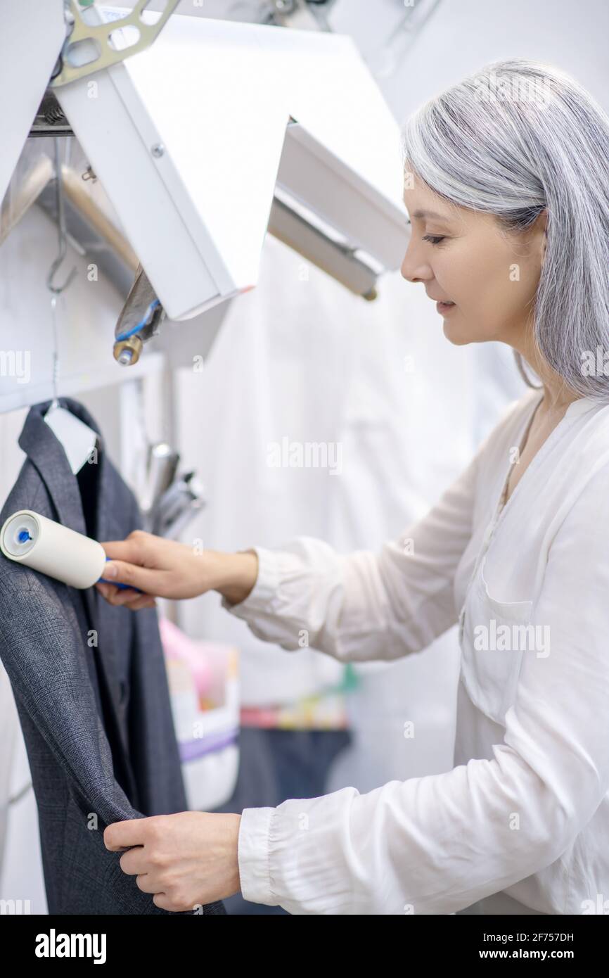Woman cleaning lint roller hires stock photography and images Alamy
