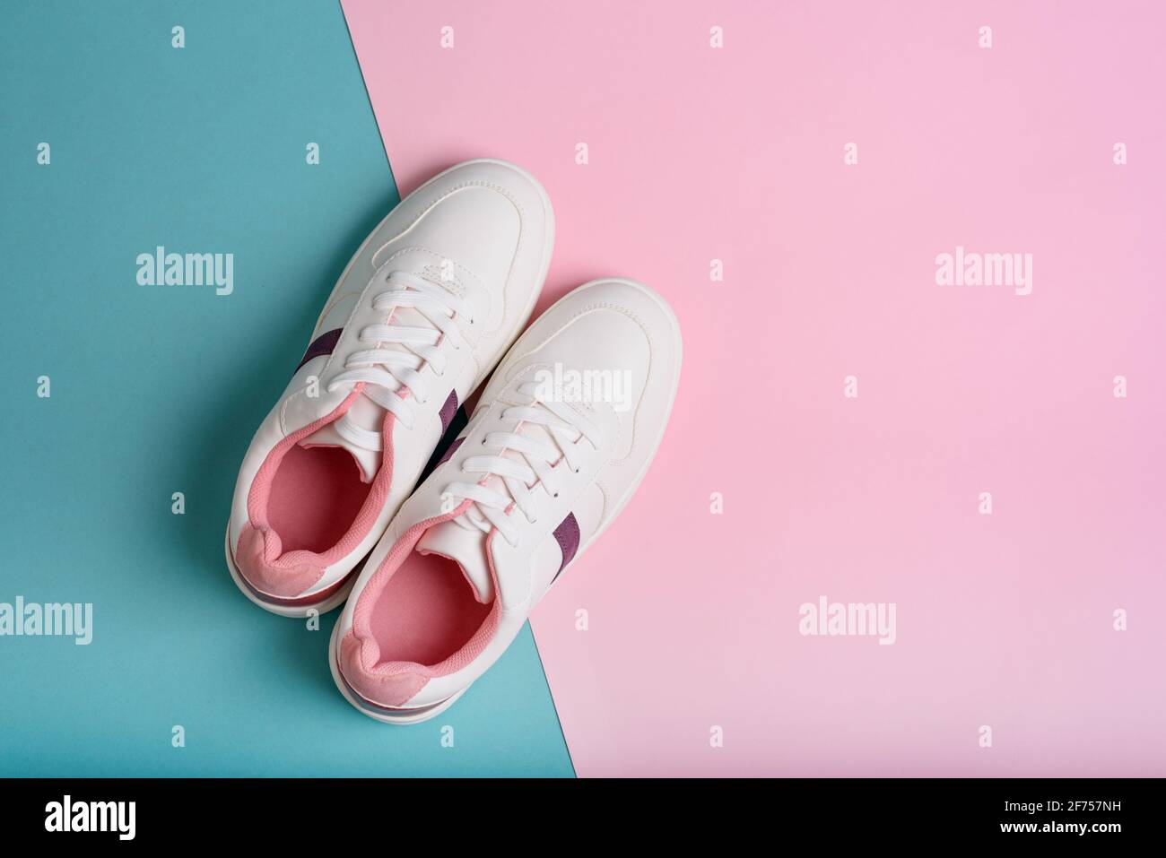 Flat lay of sport sneakers shoes on the blue and pink background ...