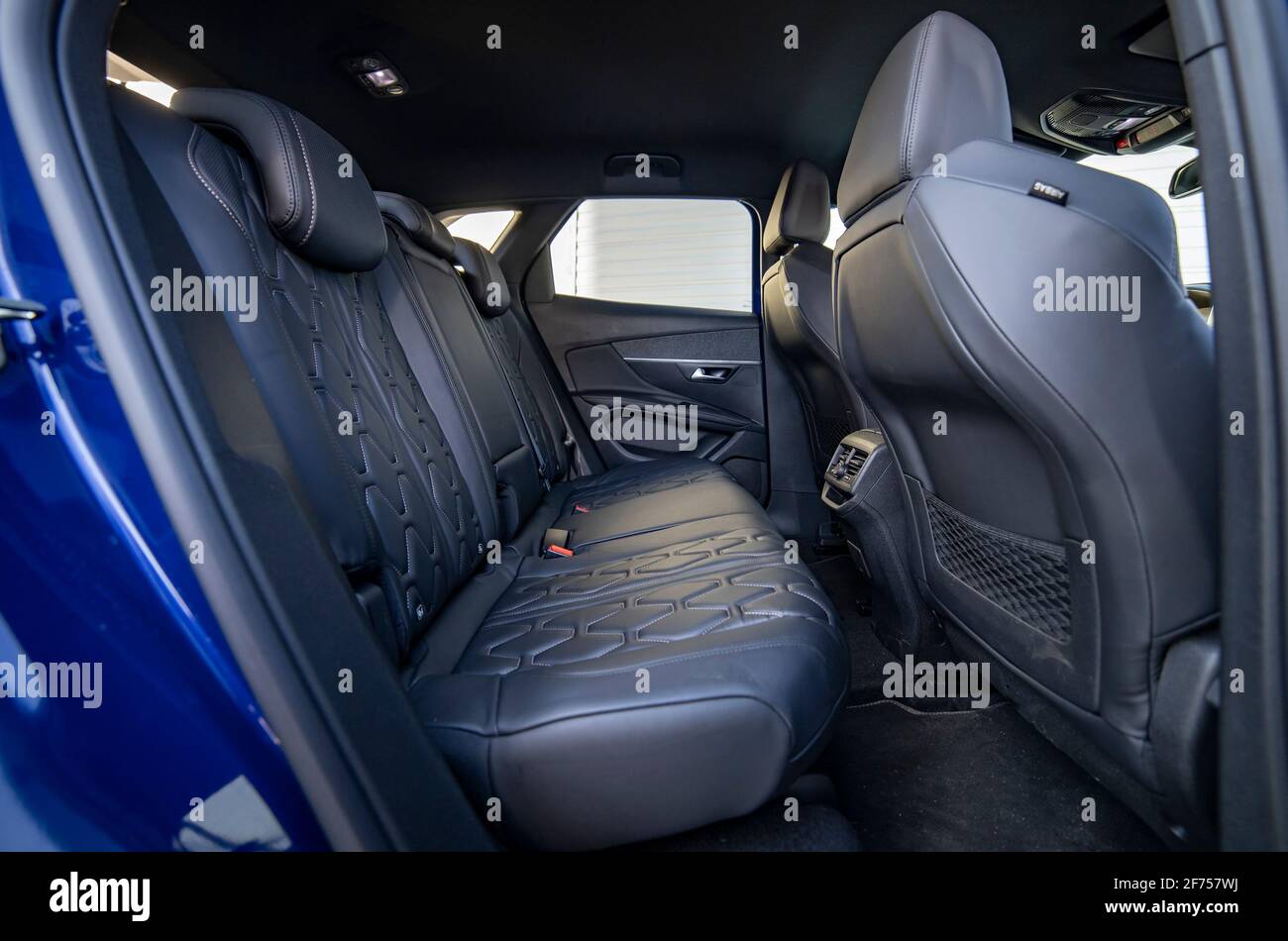 Row of passenger rear seats upholstered in black interior modern passenger car Stock Photo