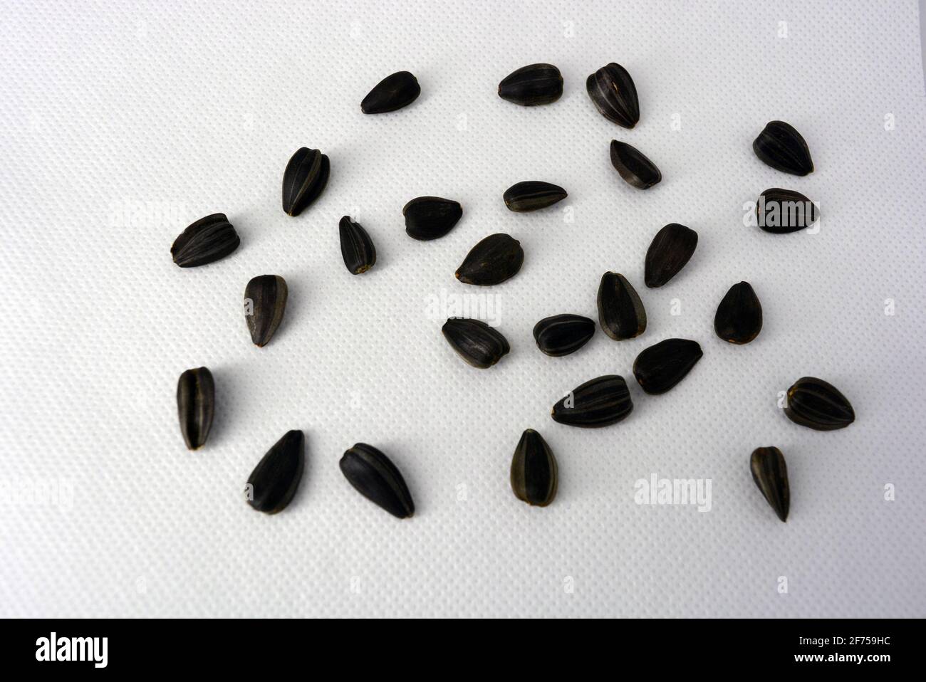 Delicious fried black sunflower seeds fastened into plastic containers ...