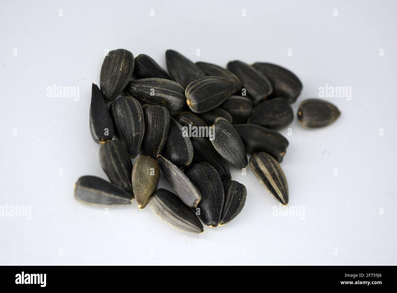 Delicious fried black sunflower seeds fastened into plastic containers ...