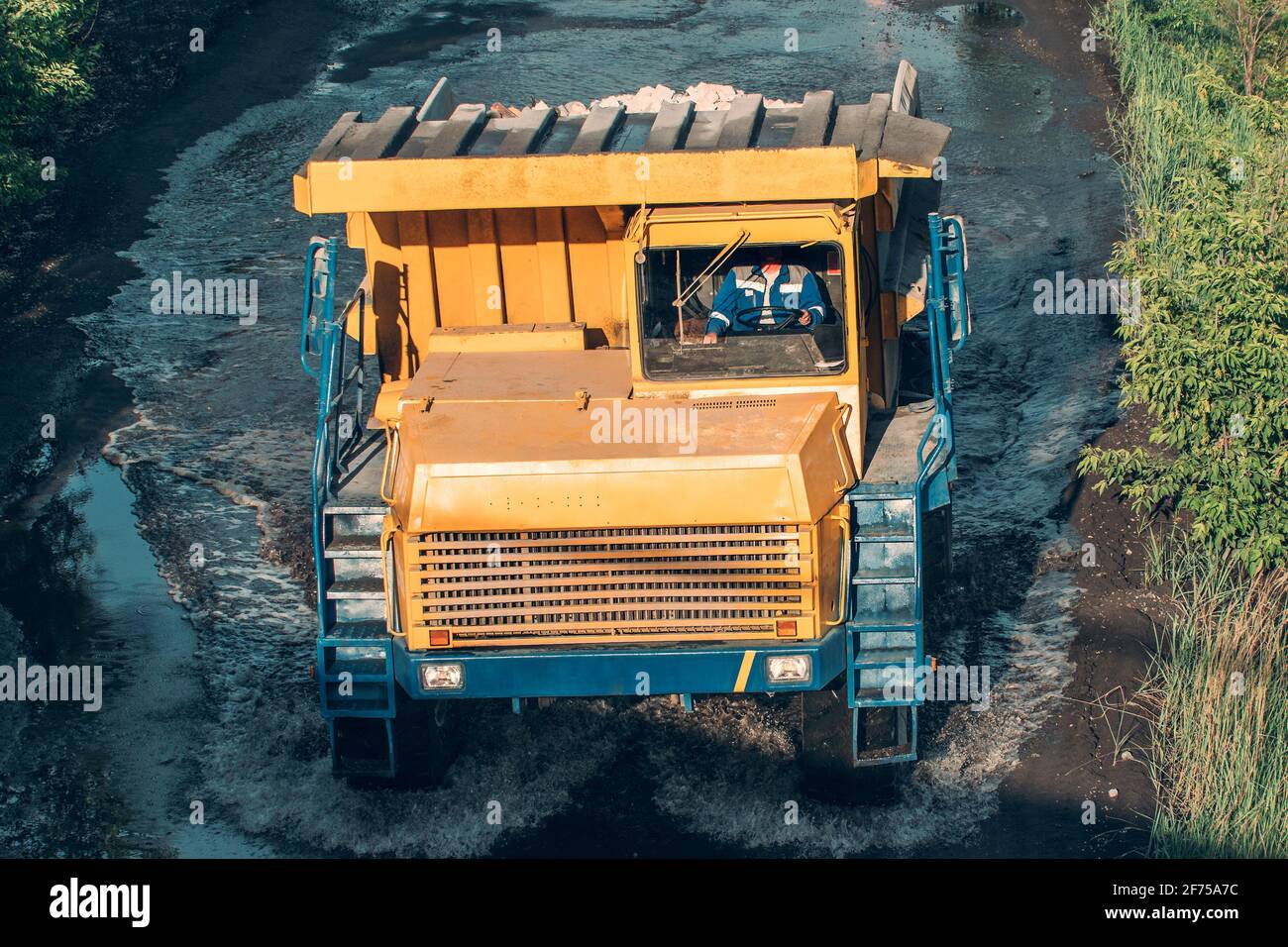 Big yellow mining truck in open pit mine industry. Stock Photo