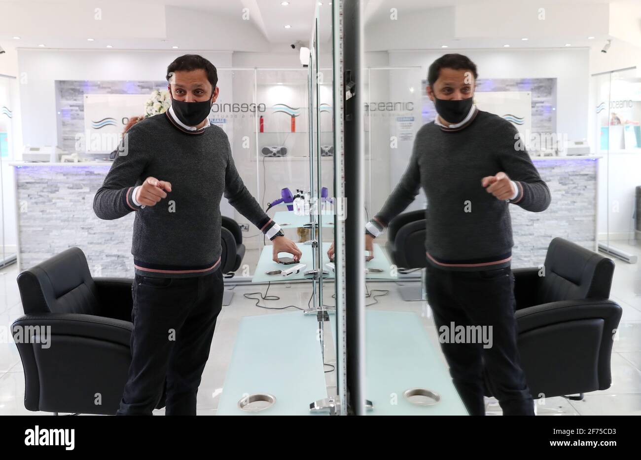 Scottish Labour leader Anas Sarwar looks in a mirror after having his