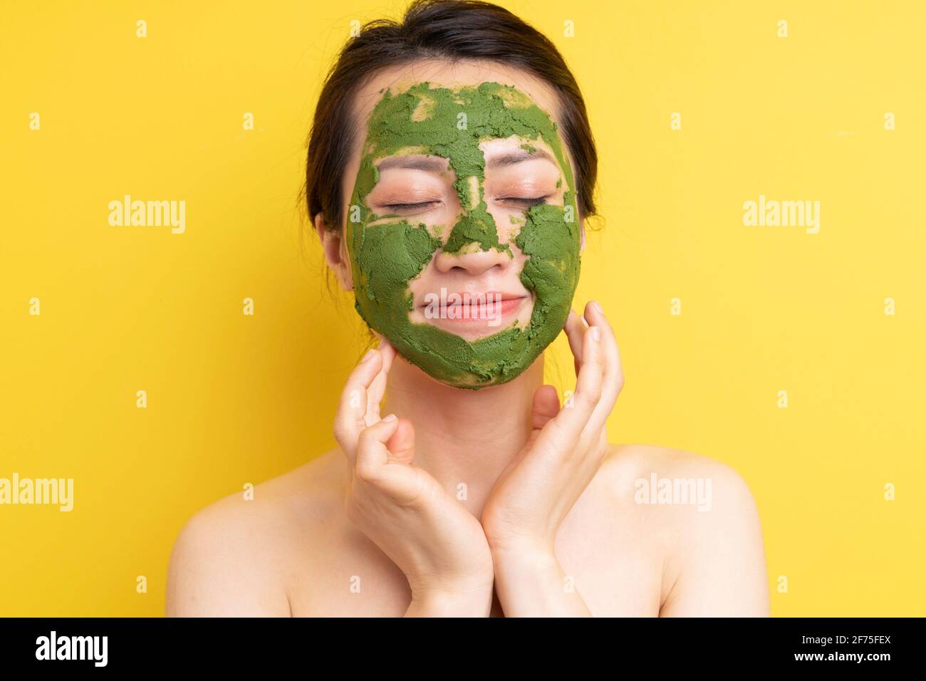 Young girl masked to exfoliate, beautify herself Stock Photo