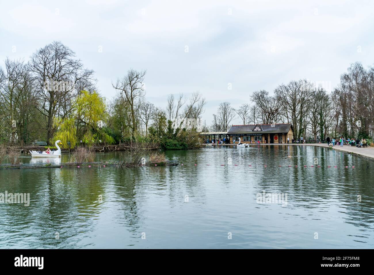 LONDON, UK - MARCH 31 2021: View of boating lake with Lakeside Café and pedal boats on at Alexandra Palace in London Stock Photo
